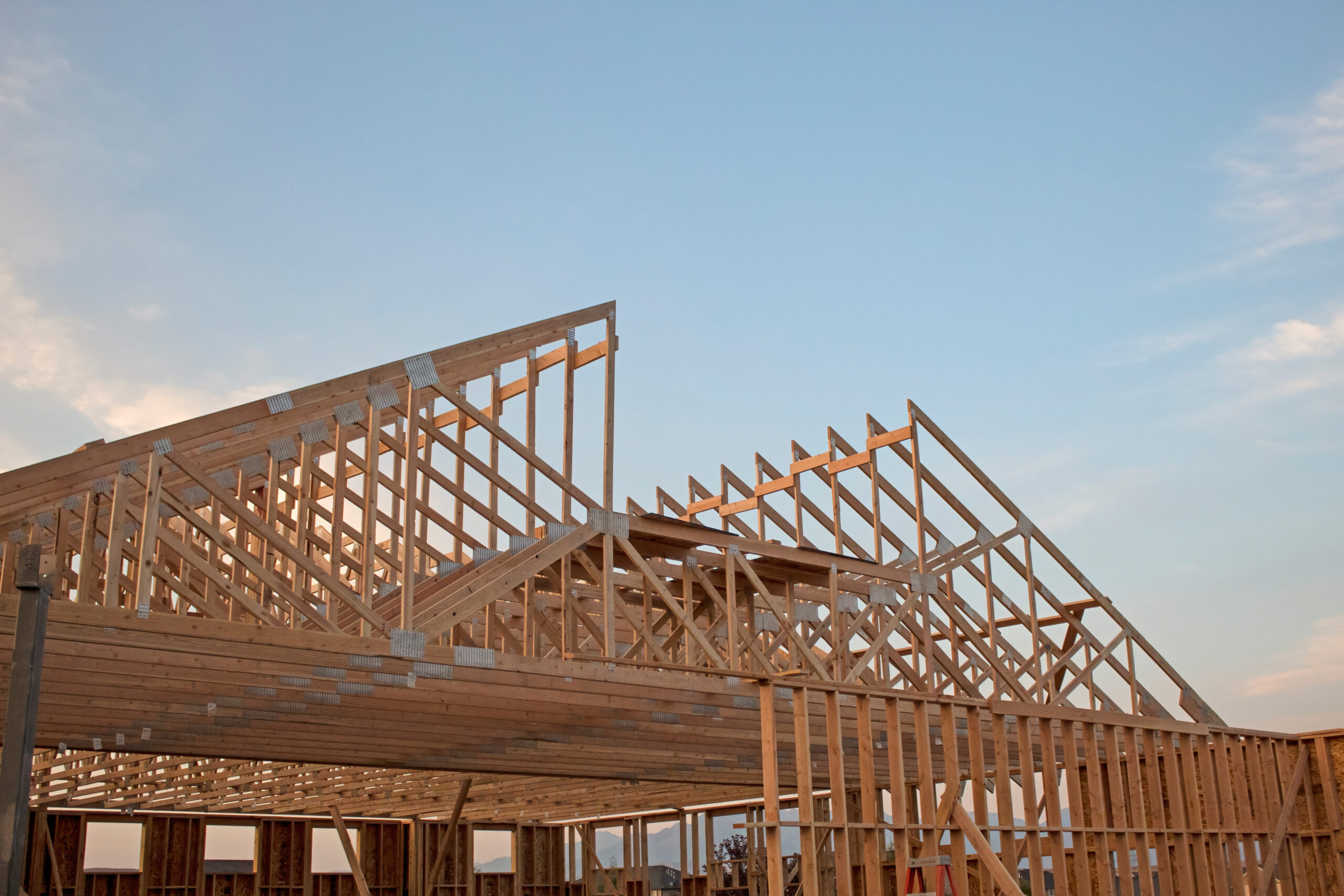 A wooden home frame for a home under construction