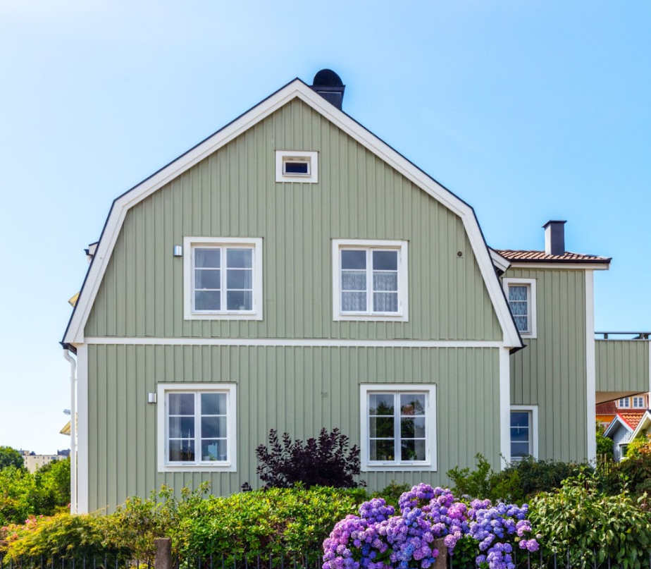 green cladded home with barn roof type
